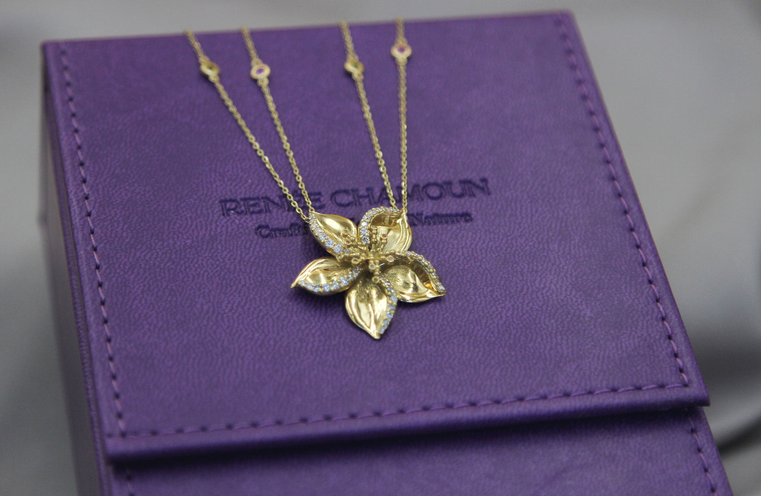 Gold frangipani necklace designed by Renée Chamoun